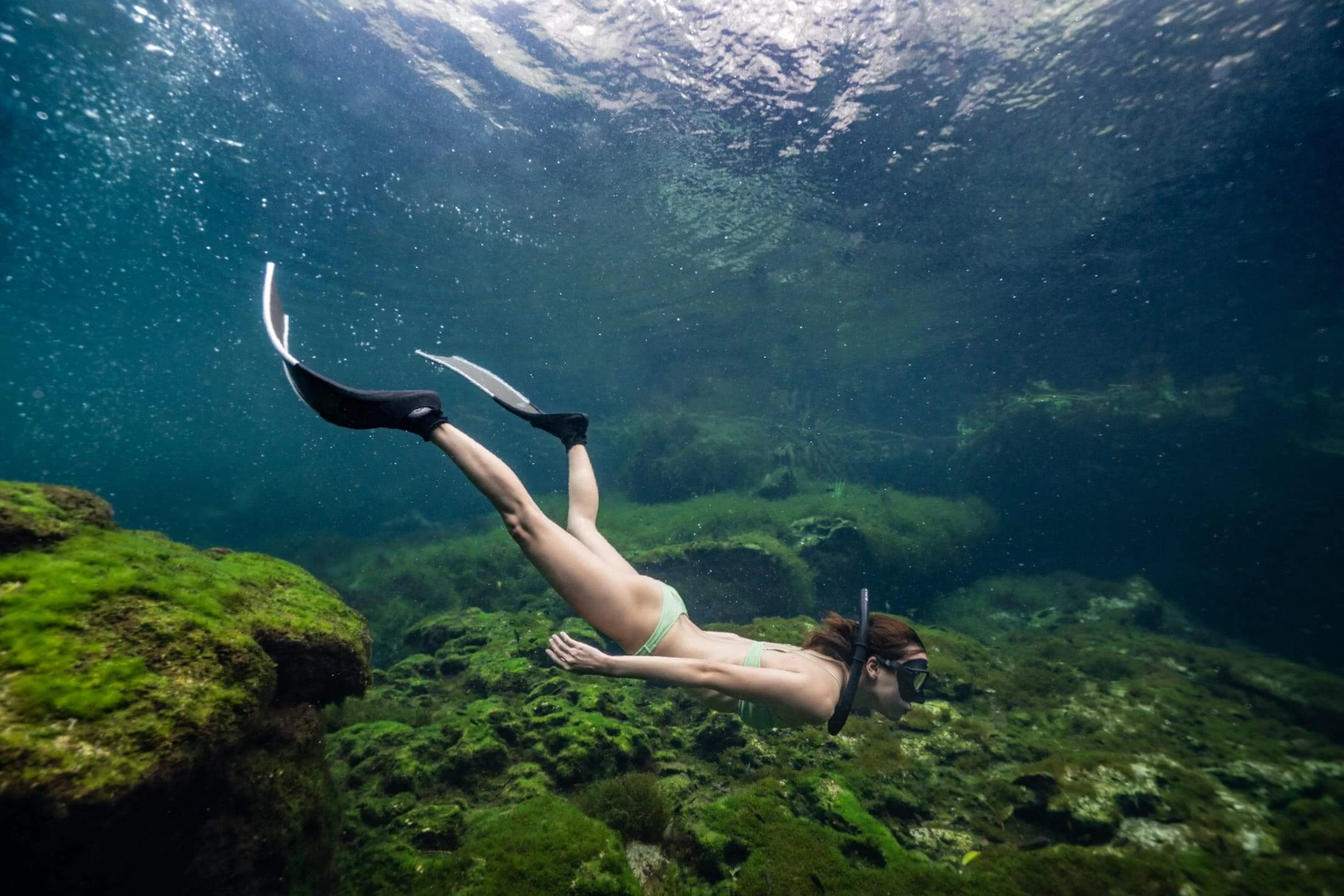 Girl freediving in warm tropical water